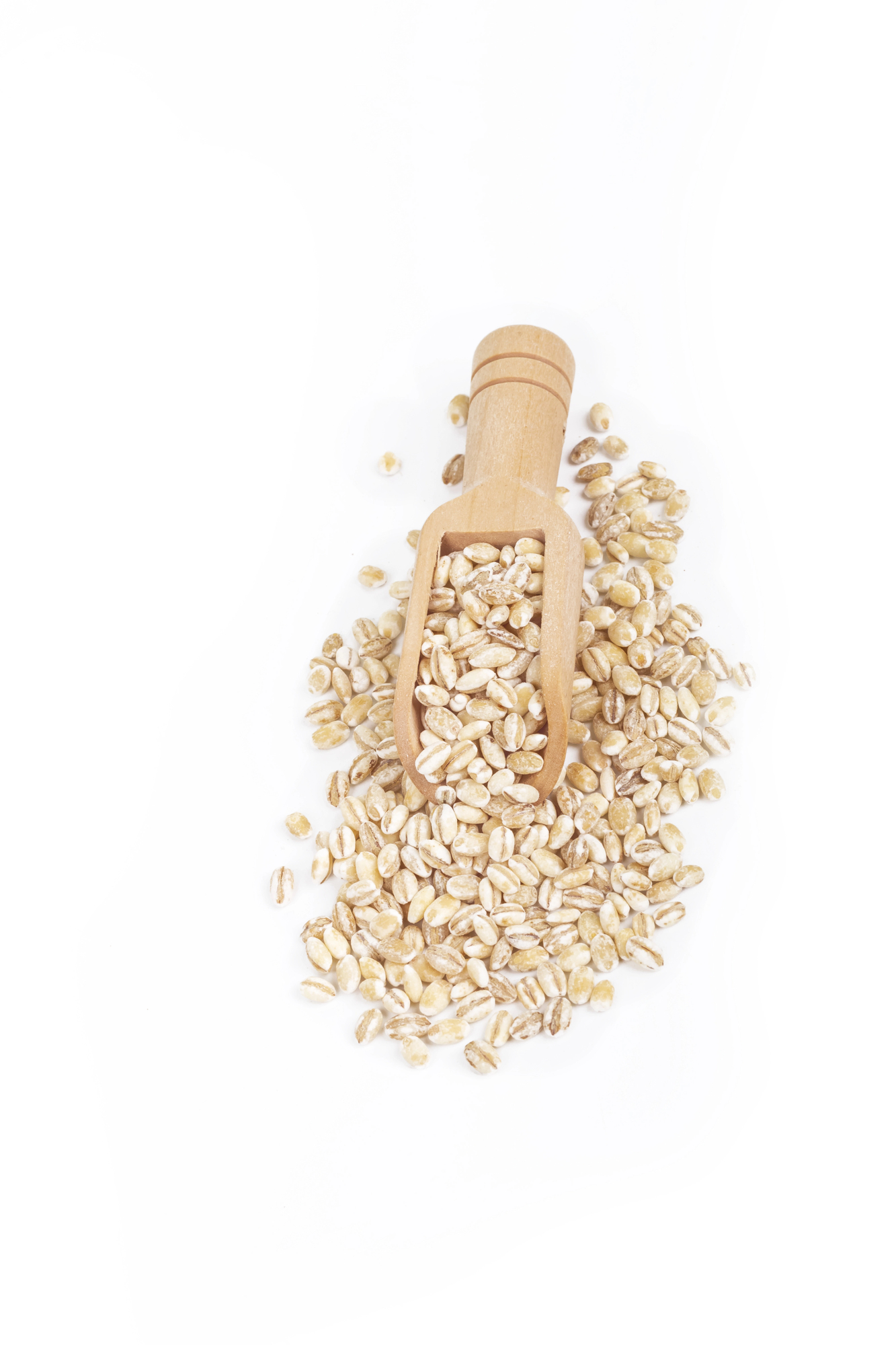 Wooden scoop filled with pearl barley