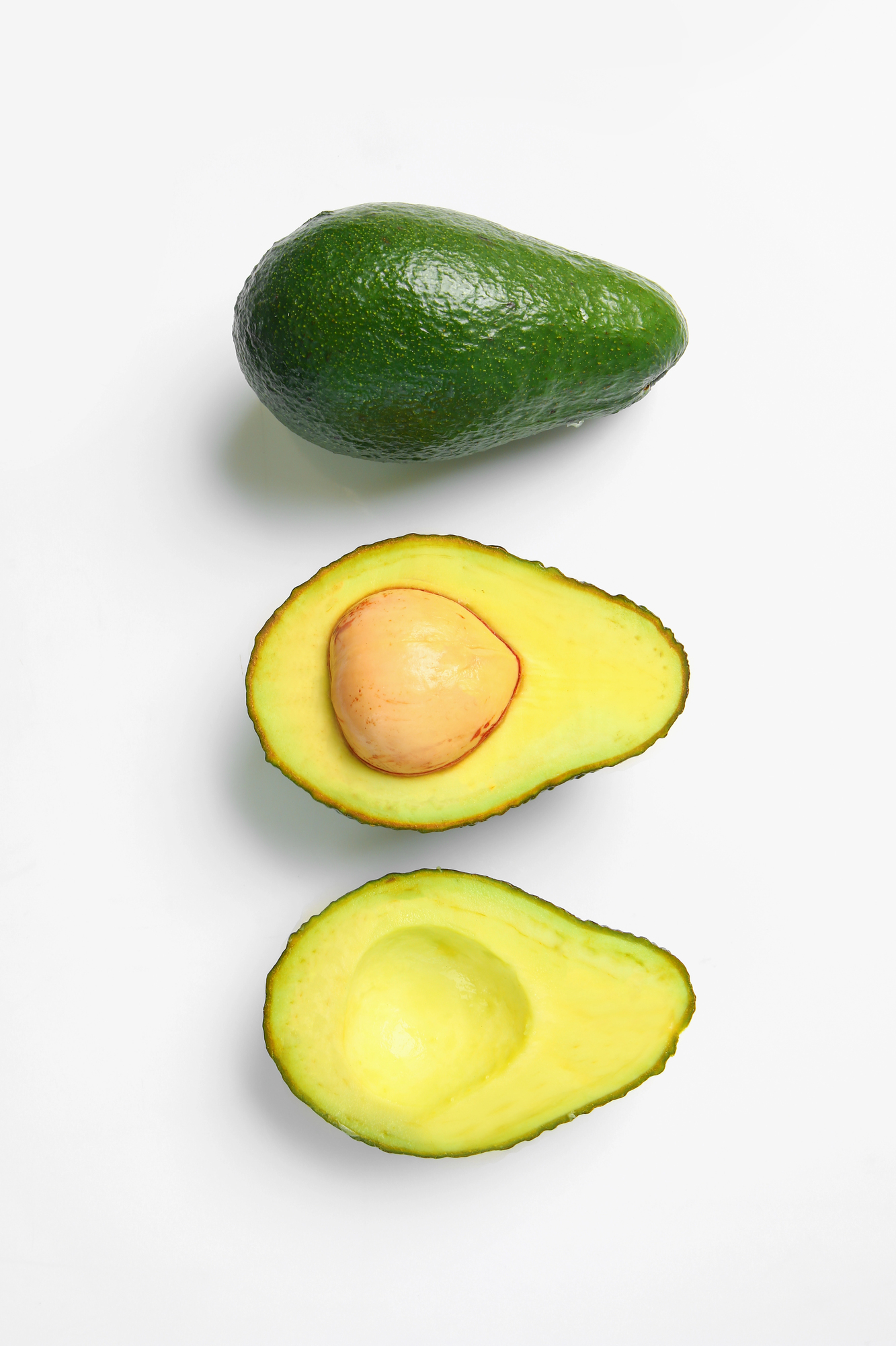 Whole avocado and two avocado halves