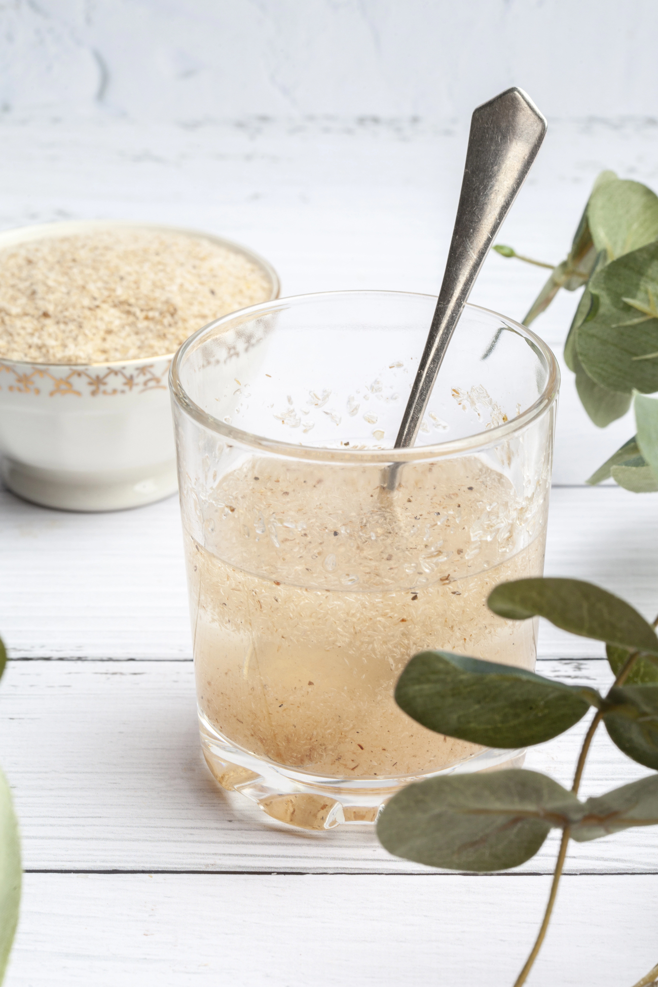 Psyllium gel in glass with spoon and bowl of powder
