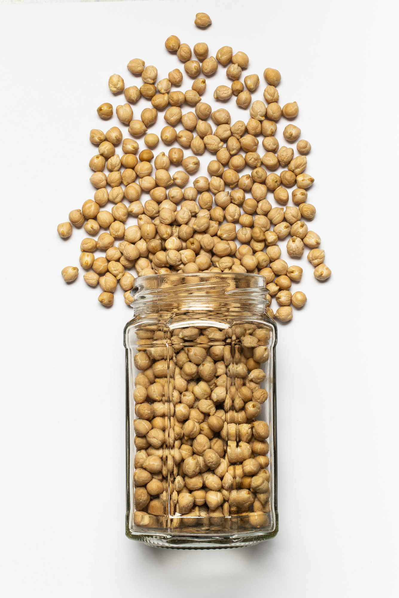 Chickpeas overflowing from glass jar