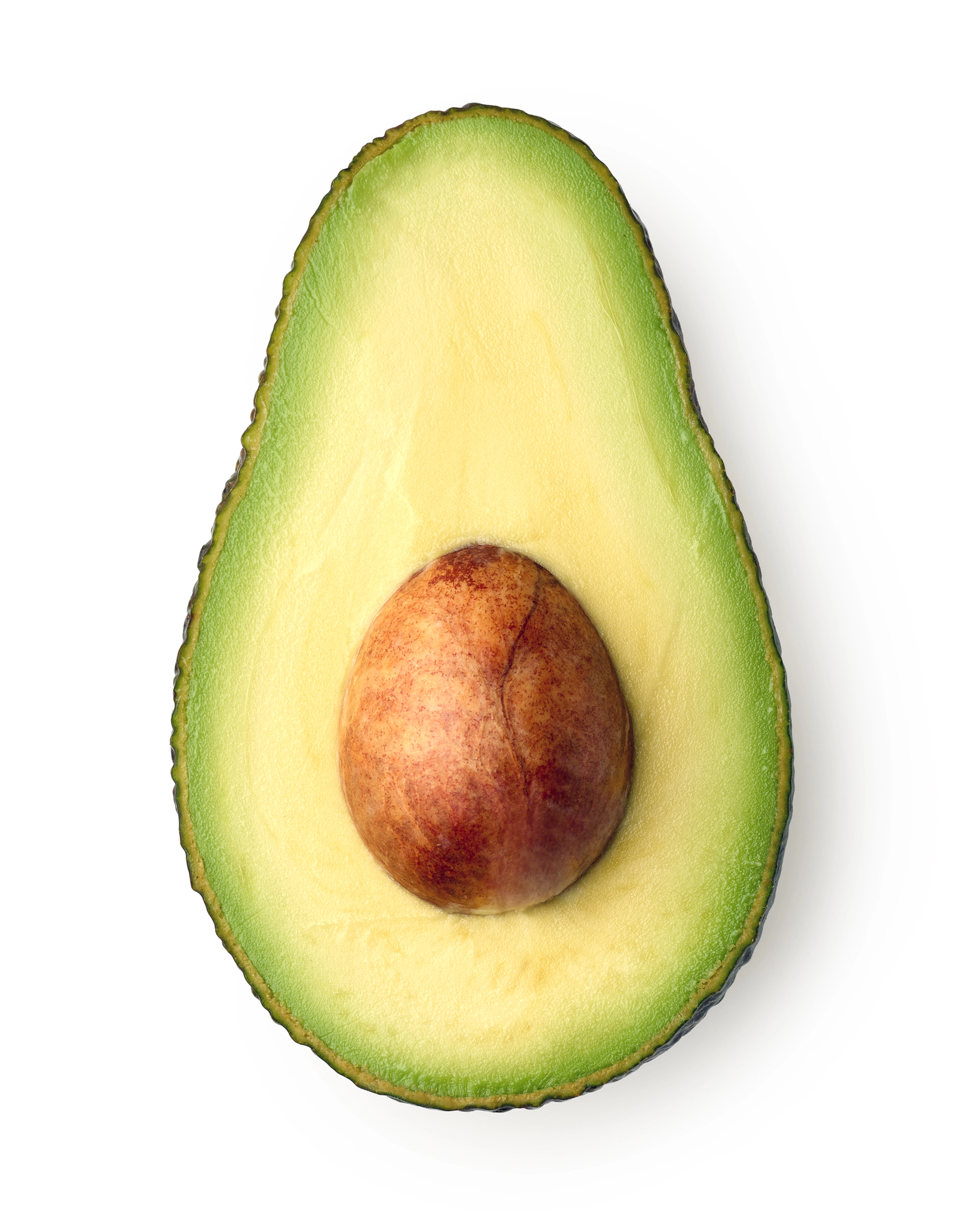 Half of a ripe avocado with pit visible
