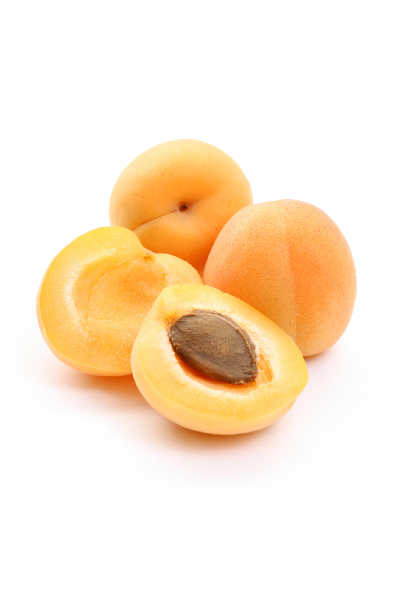 Whole and halved apricots with pit exposed