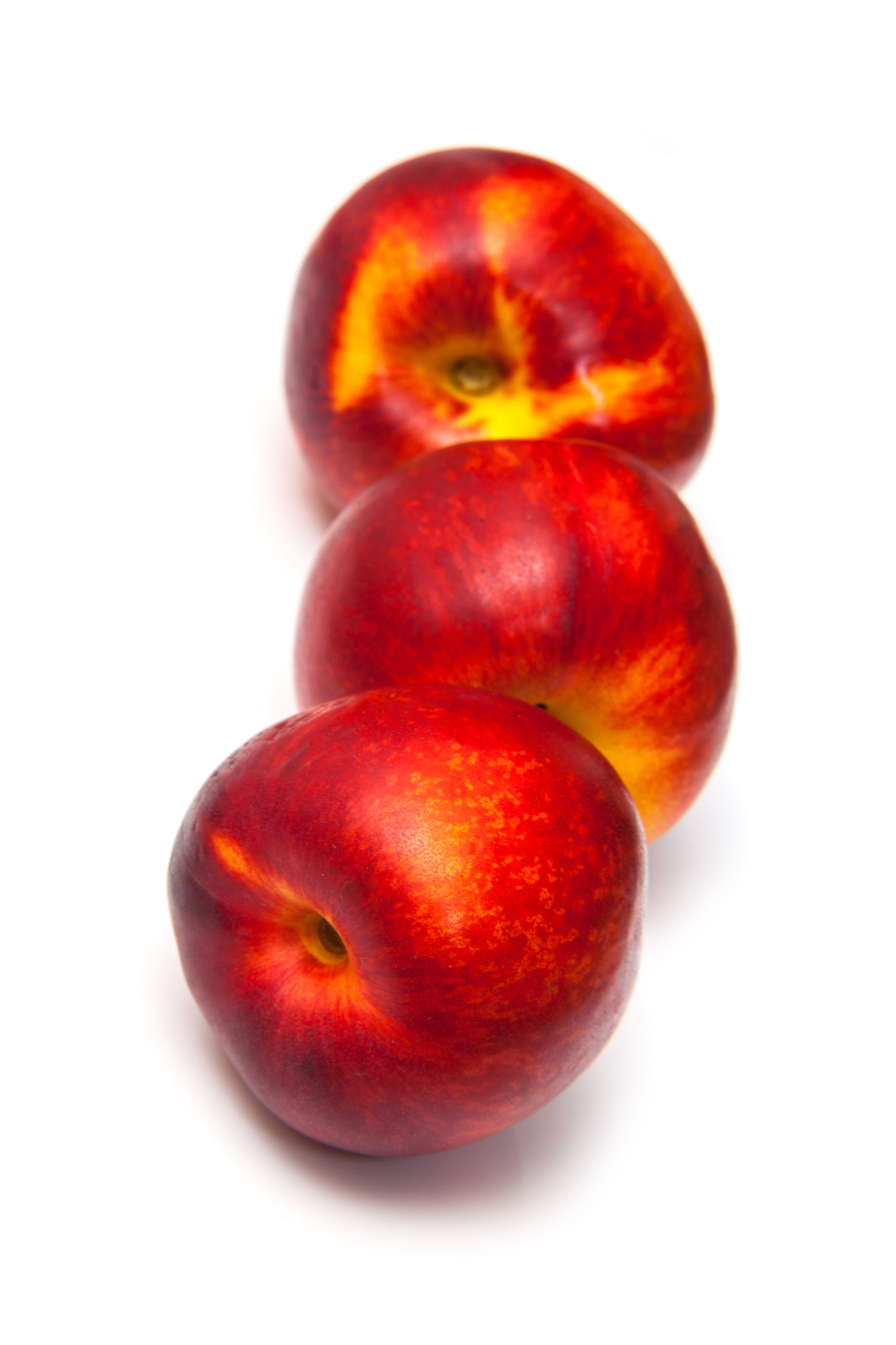 Three whole red nectarines