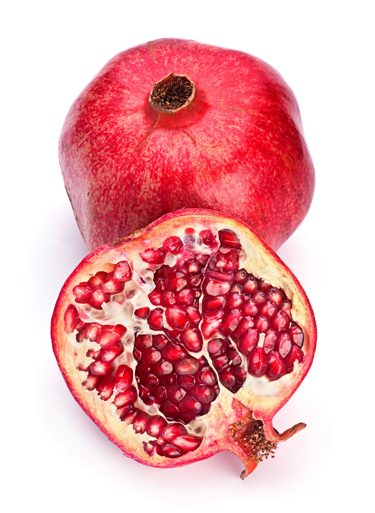 Whole and halved red pomegranate