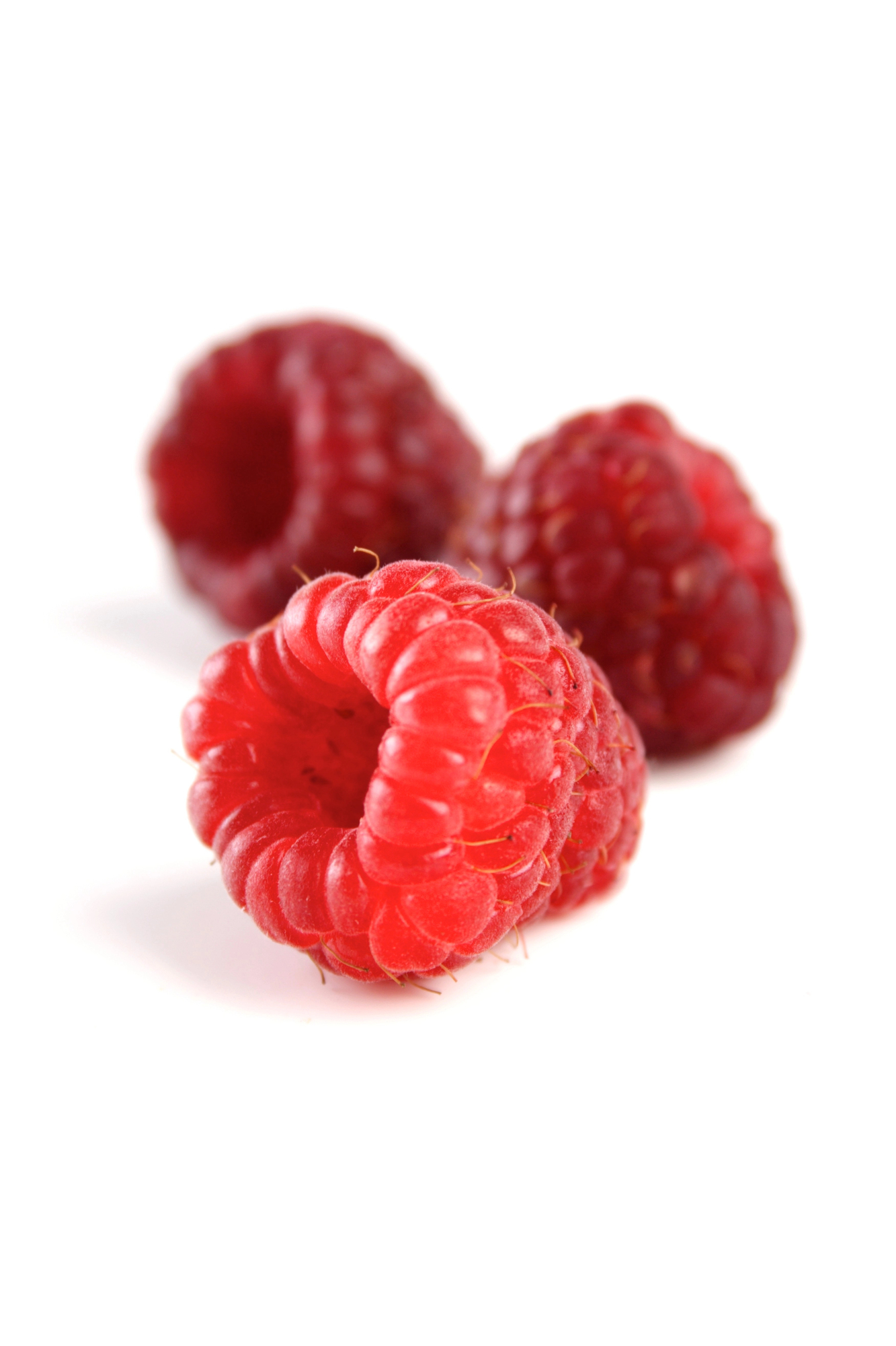 Three fresh red raspberries