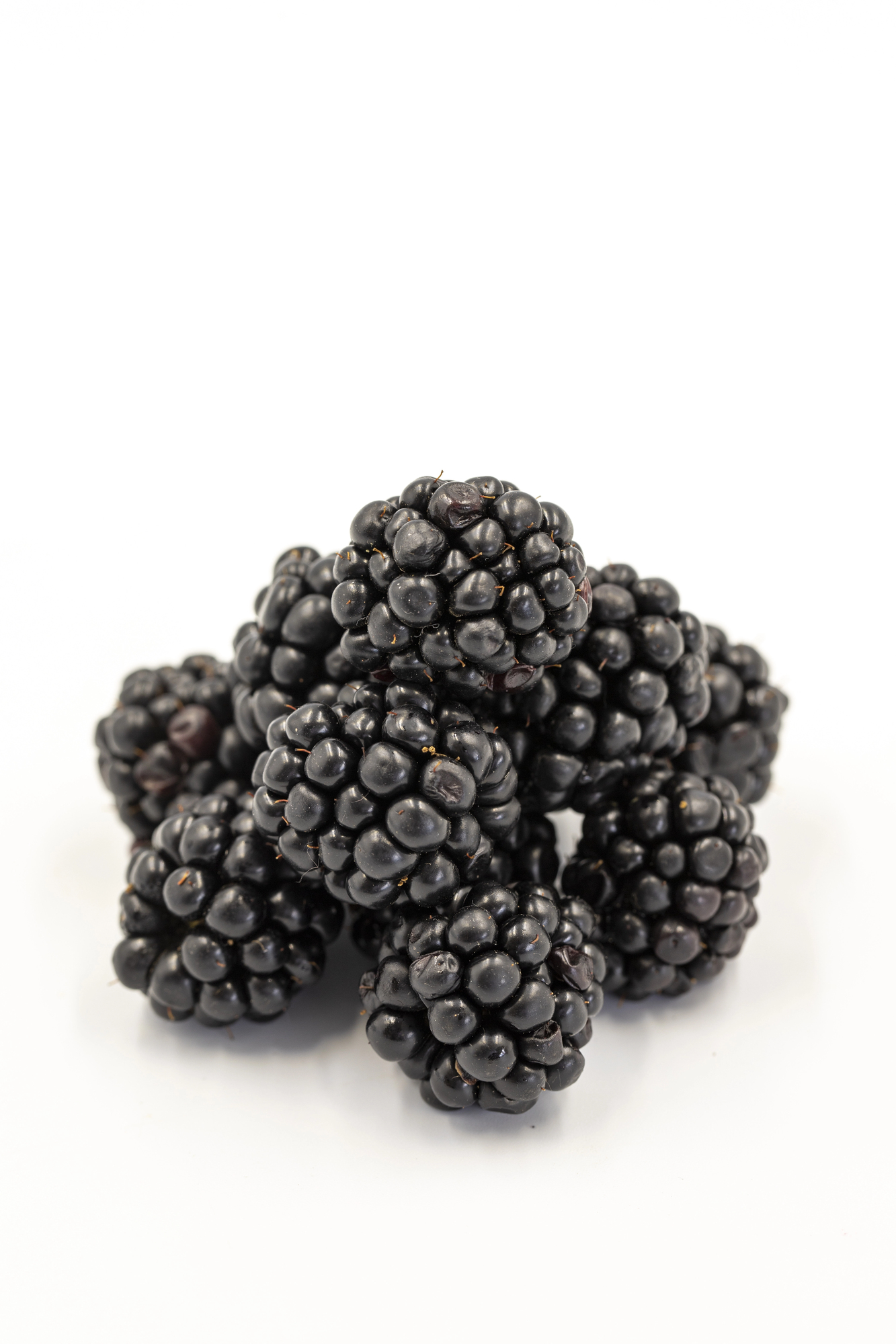 Fresh black mulberries clustered together