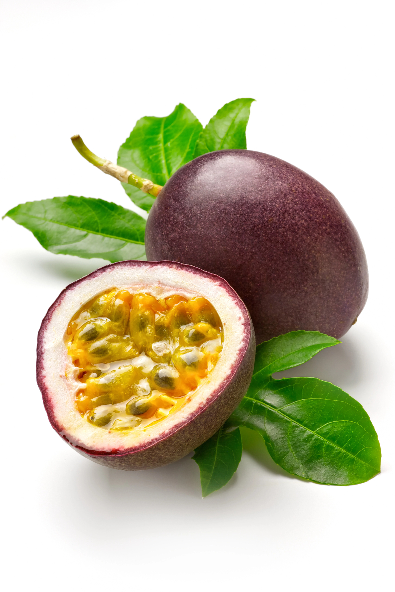 Whole and halved passion fruit with seeds