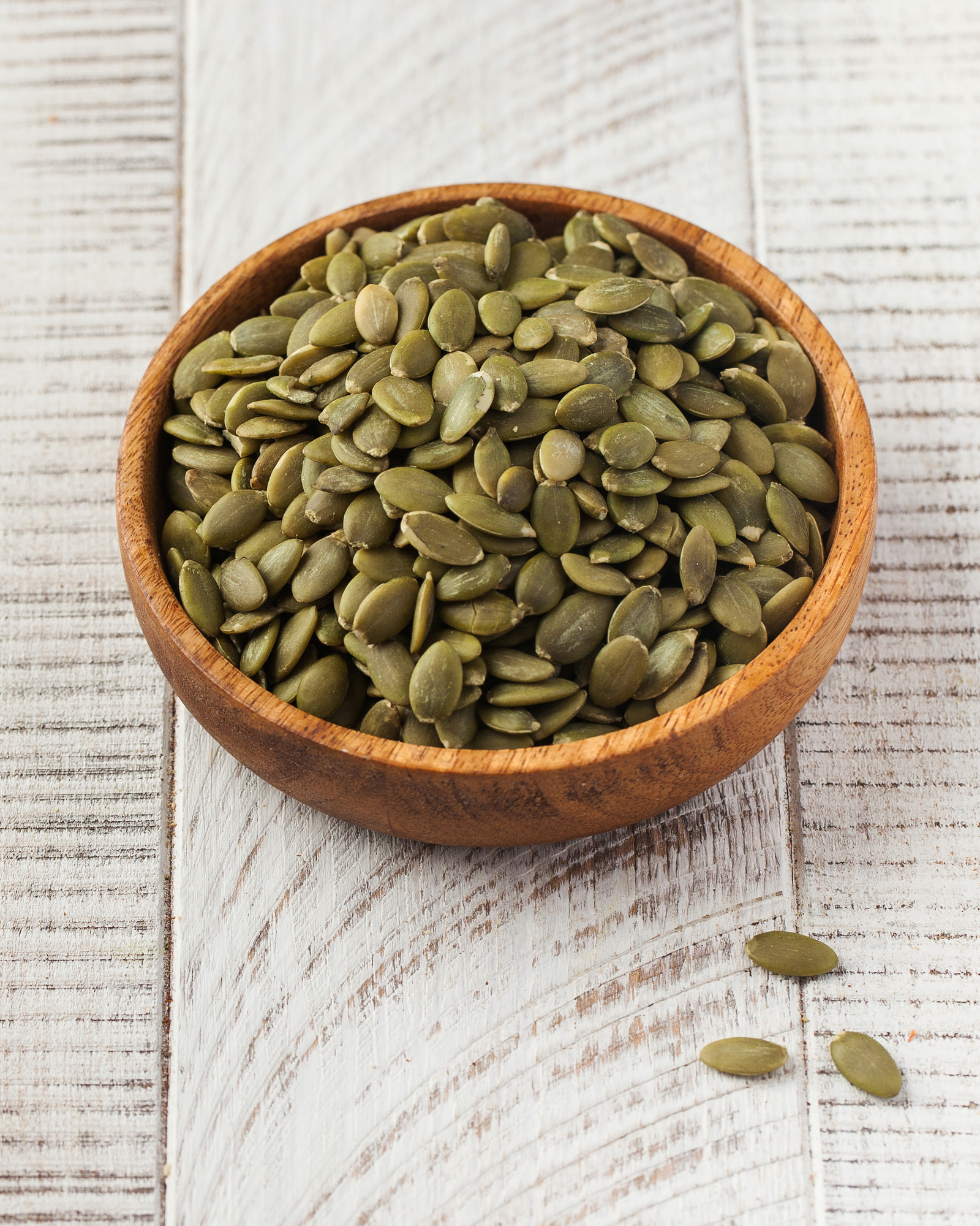 Pumpkin seeds in a wooden bowl