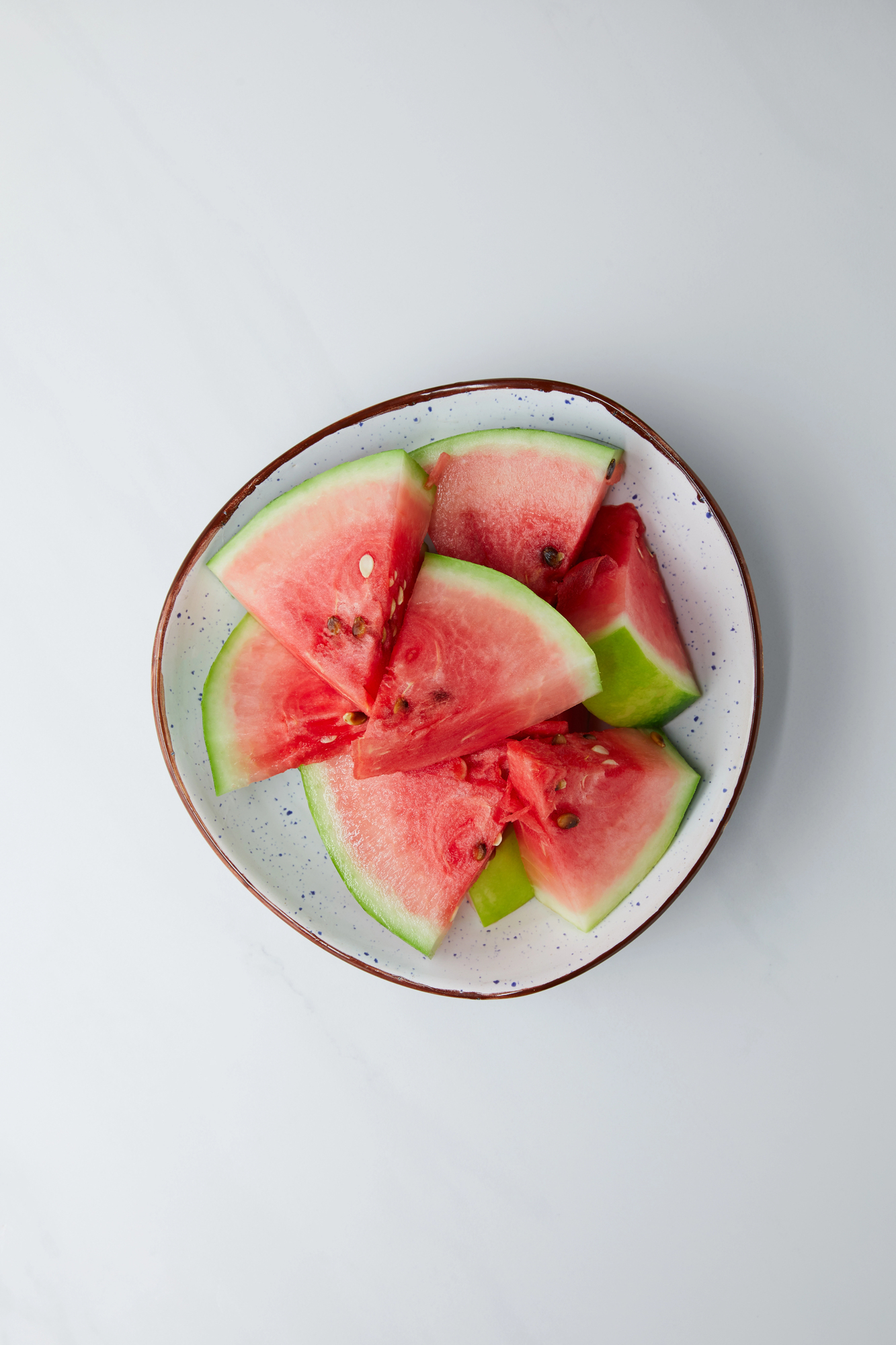 Watermelon slices and chunks in a decorative bowl
