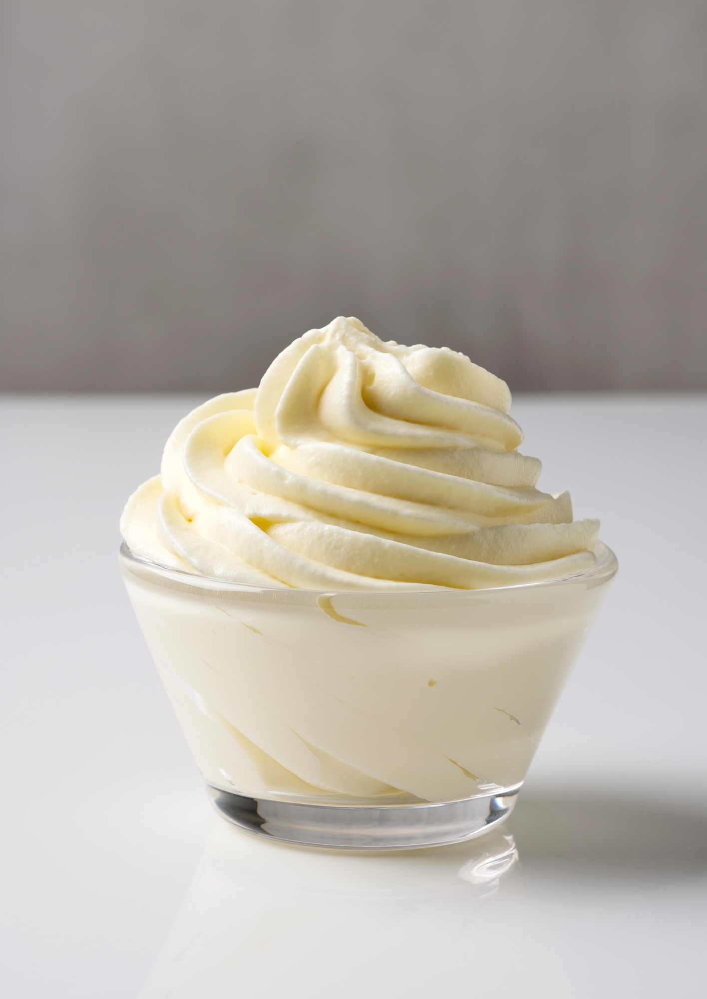 Whipped cream piped in a glass bowl