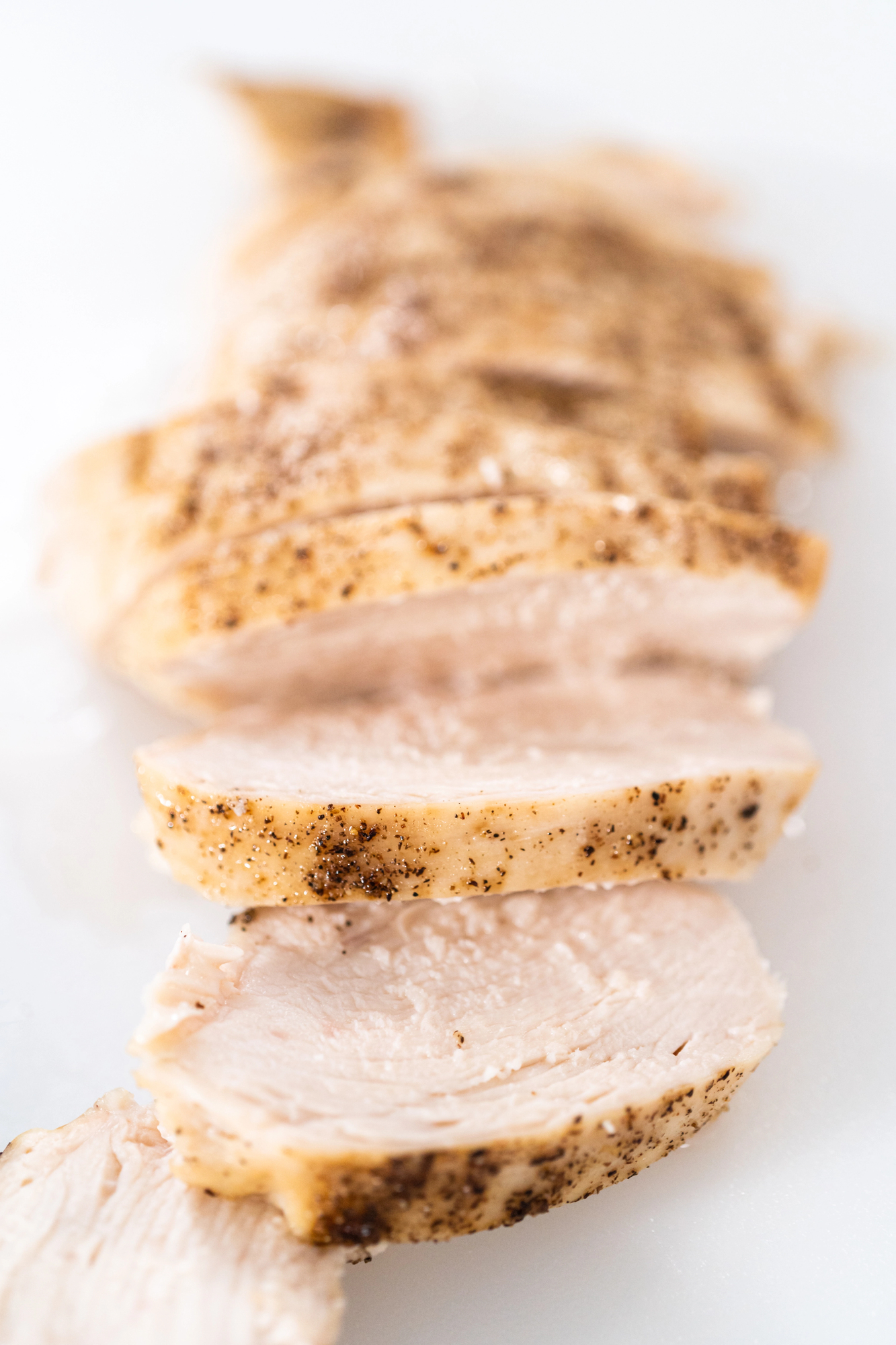 Sliced cooked chicken breast with herb crust