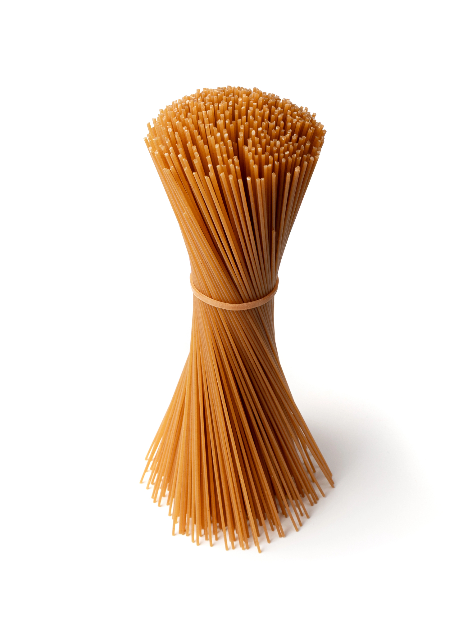 Bundle of raw brown spaghetti tied in middle