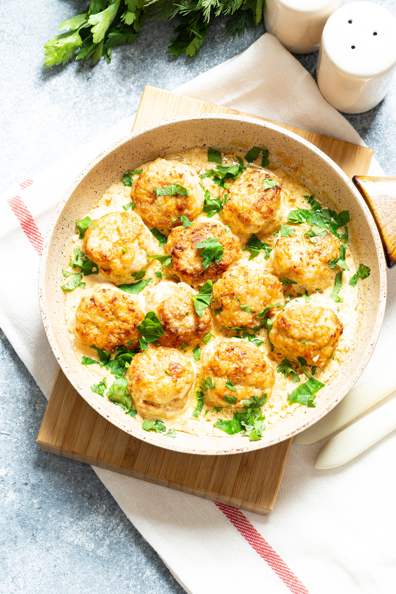 Meatballs in white sauce in a skillet