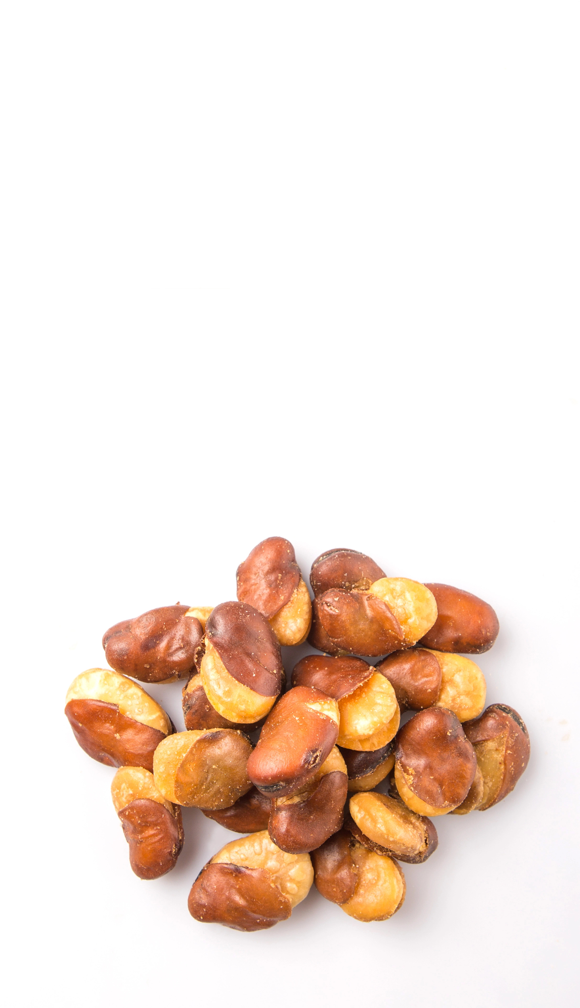 Salted broad beans scattered on white background
