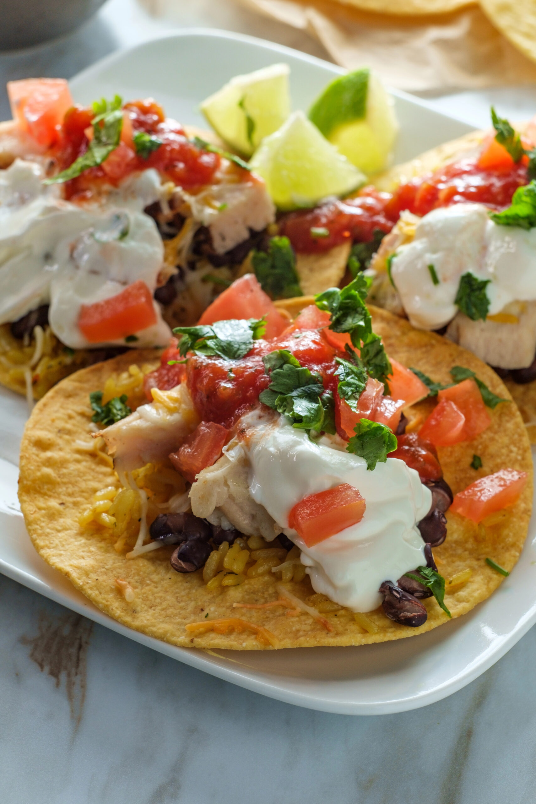 Crispy tostadas topped with chicken sour cream and salsa