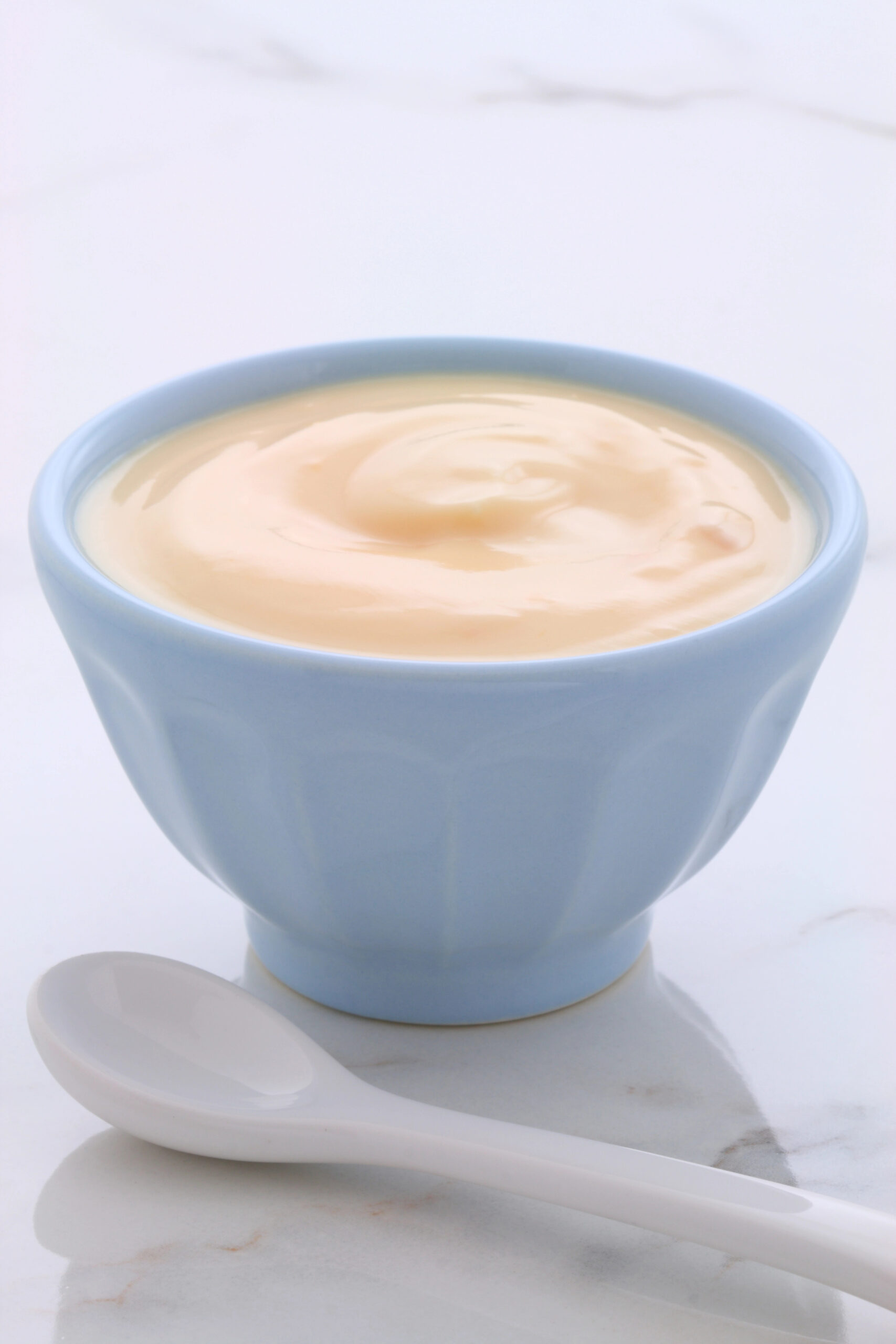 Plain yogurt in a light blue bowl