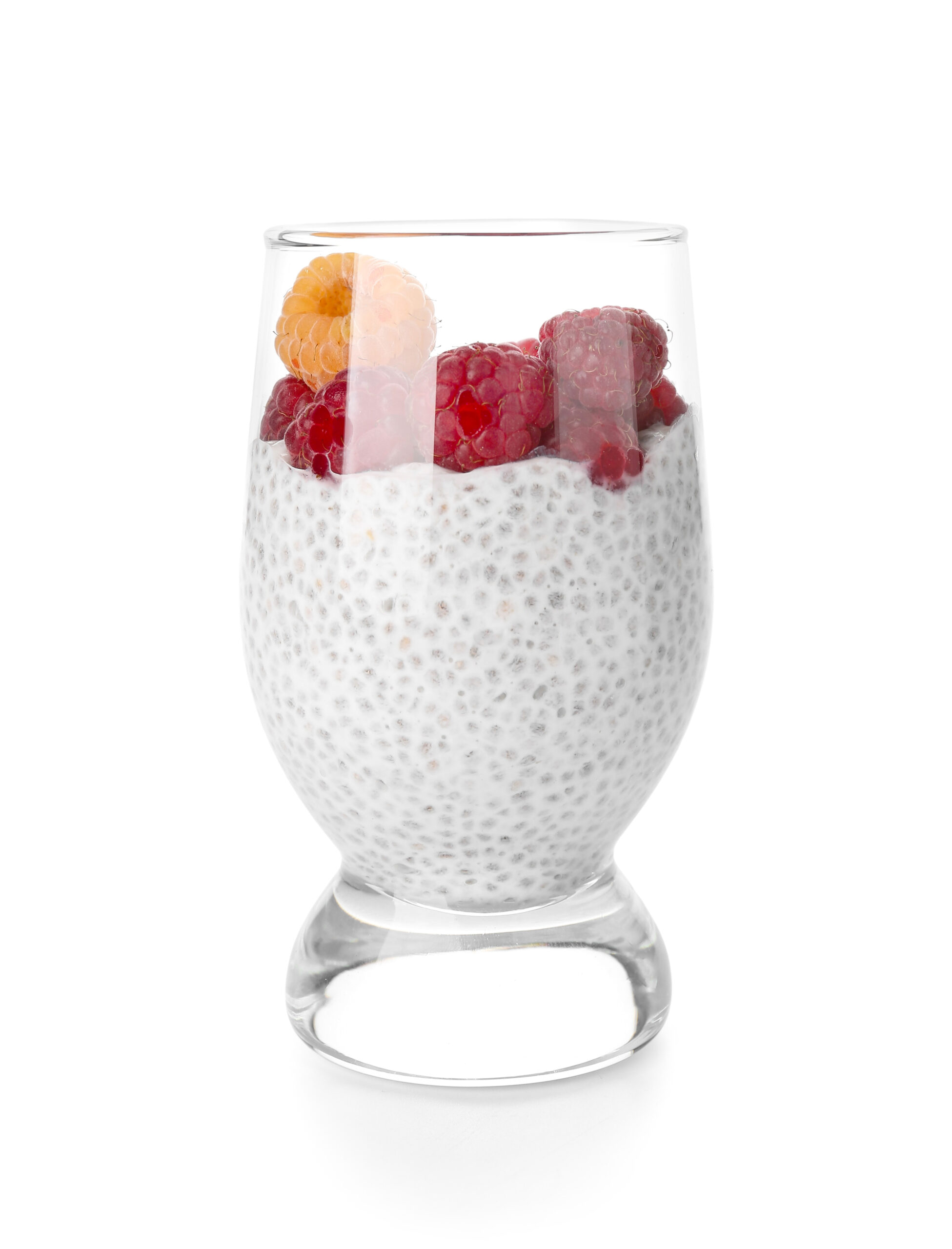 Chia seed pudding with raspberries and peach in glass