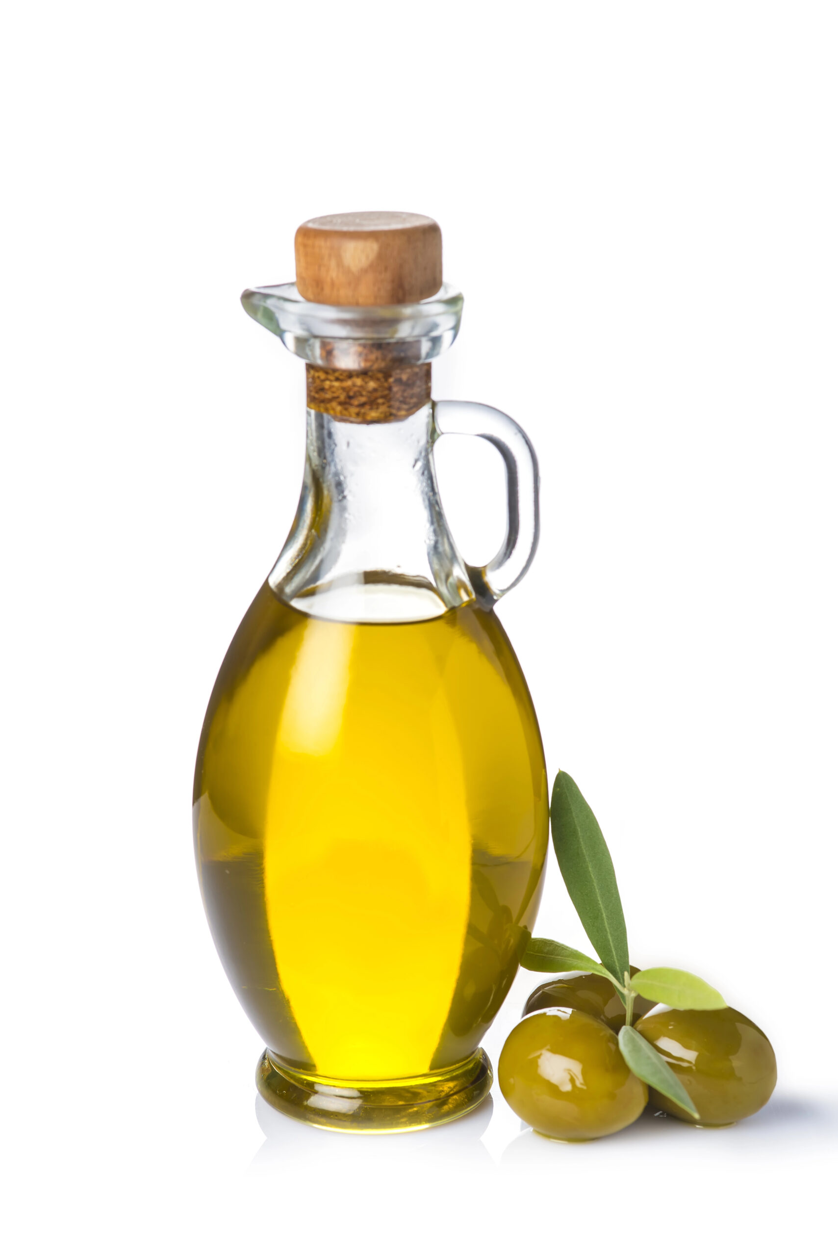 Glass bottle of olive oil with cork stopper and green olives