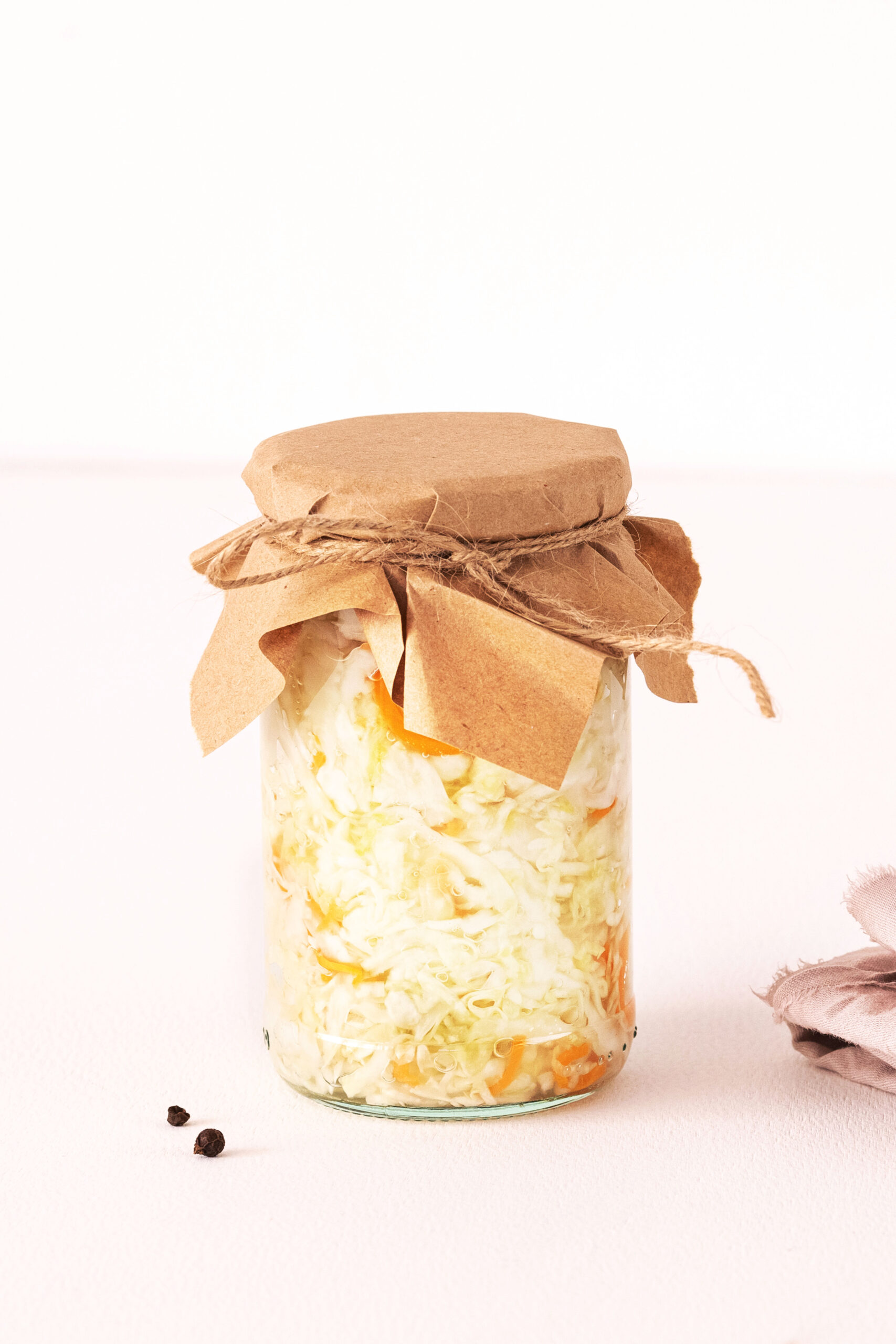 Closed glass jar of fermented cabbage and carrots