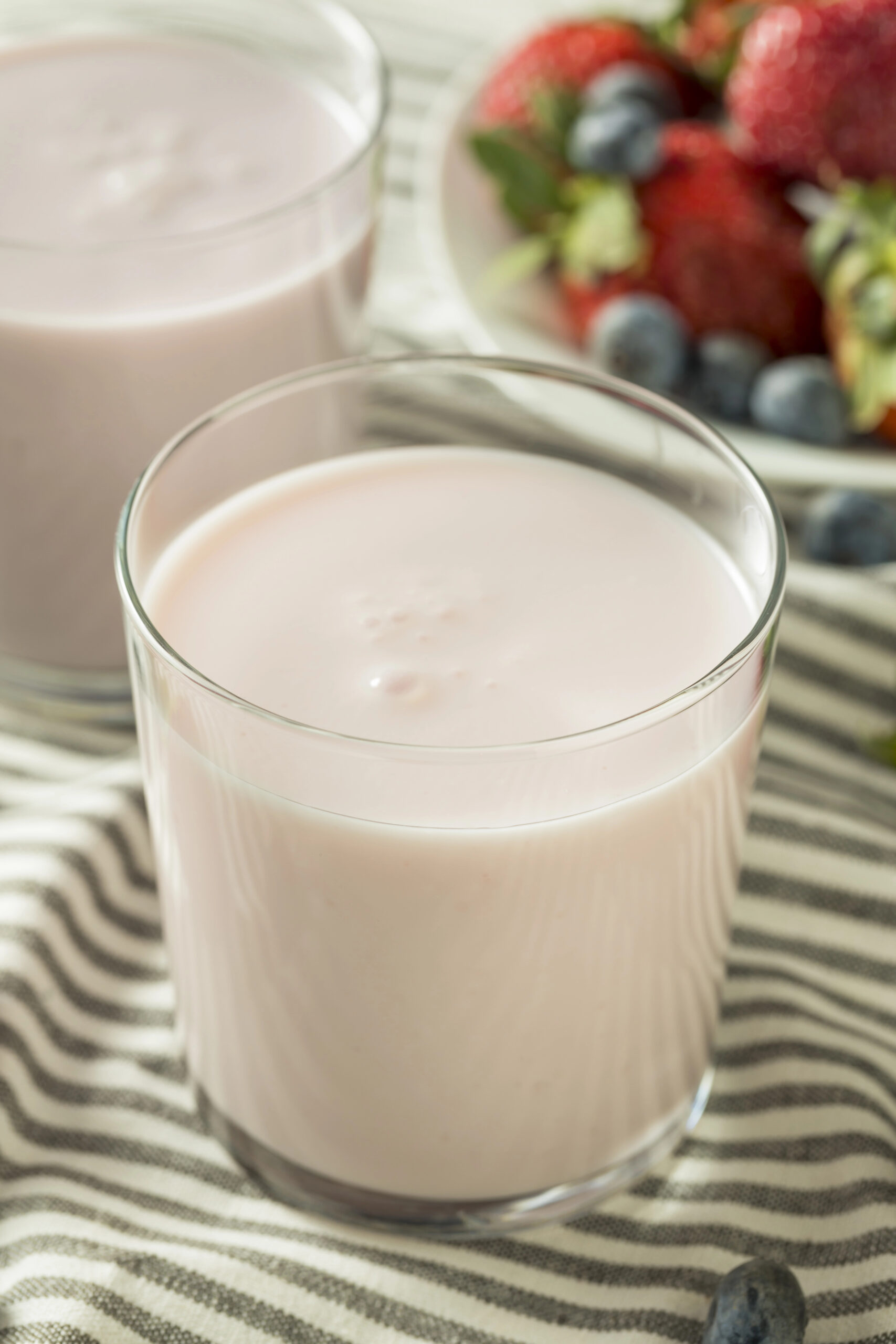 Glass of white yogurt with berries and kefir