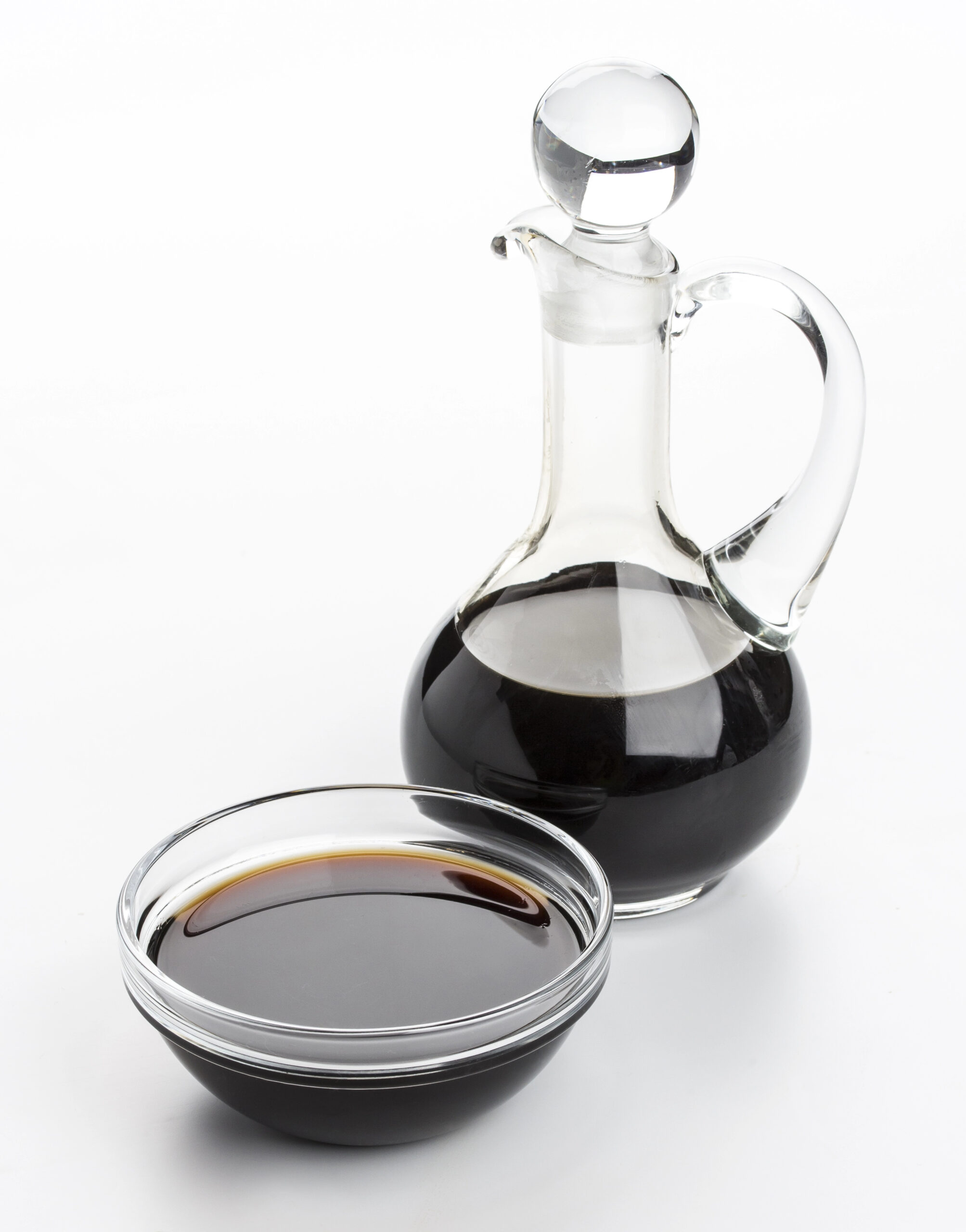 Soy sauce in glass bottle and bowl