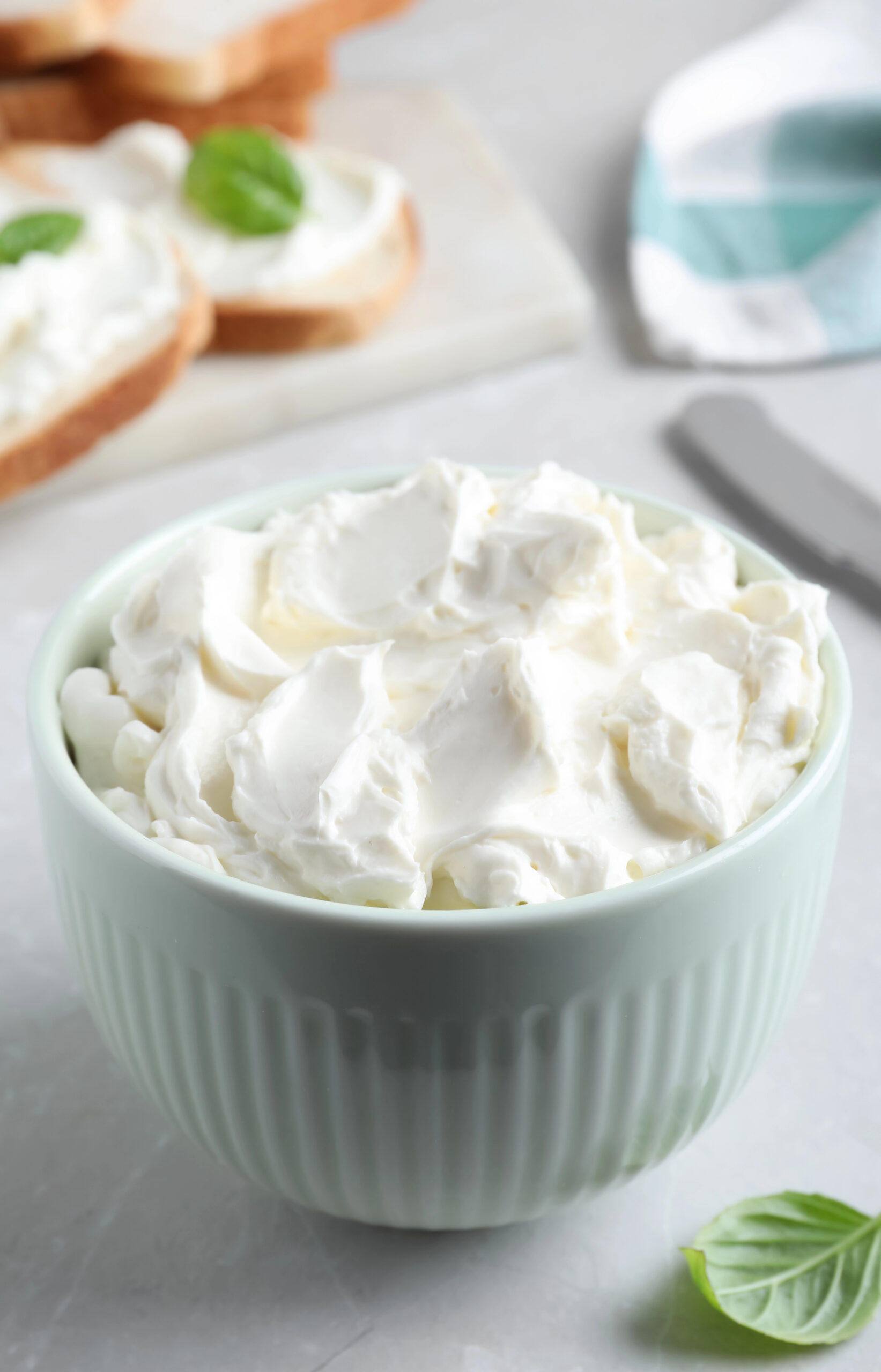 Whipped cream cheese in light green bowl