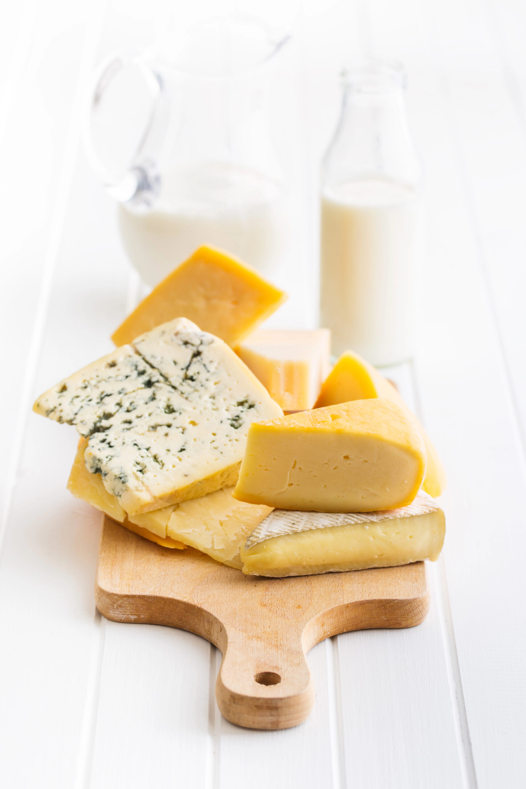 Selection of cheeses on wooden board