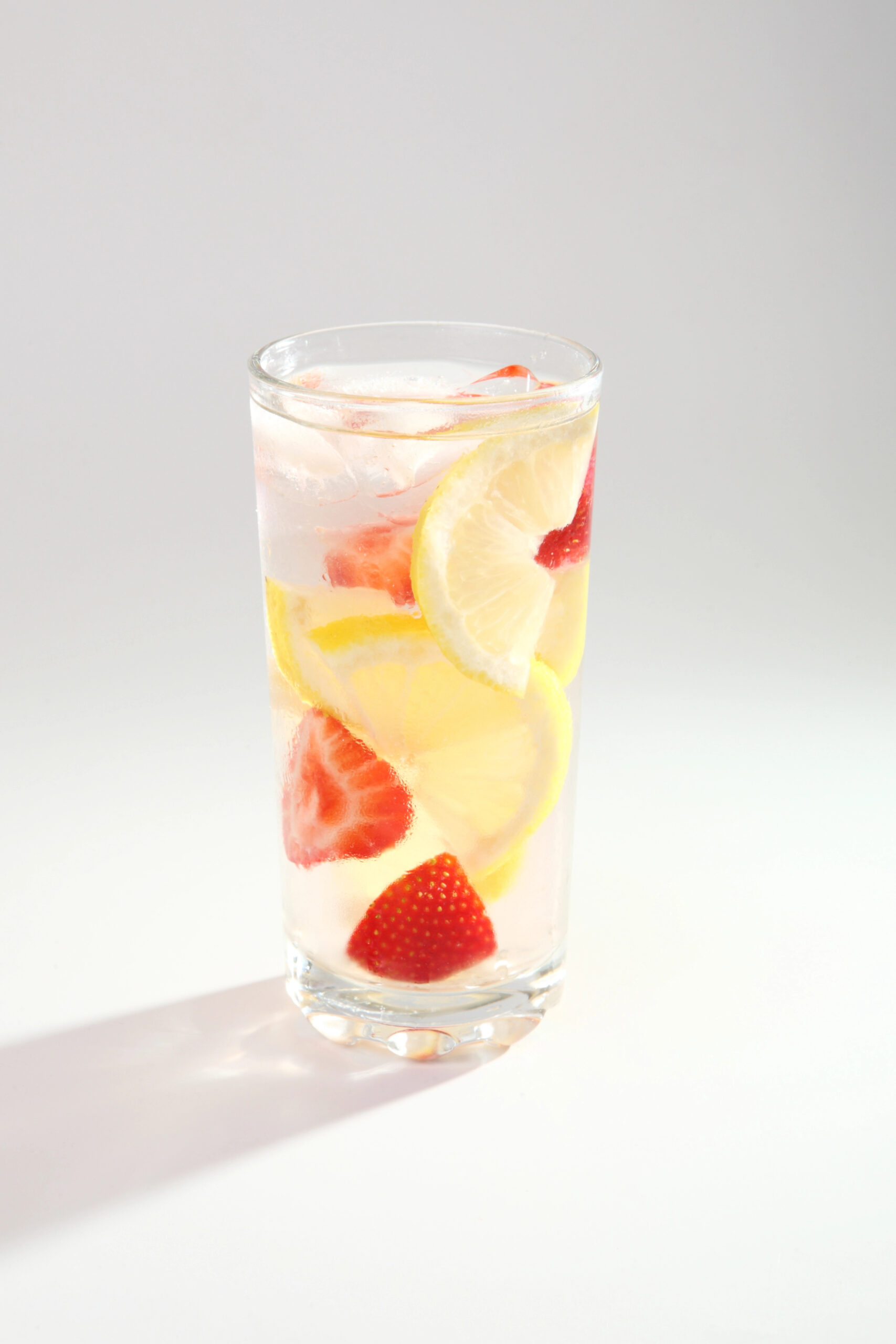 Cold drink with lemon slices and strawberries