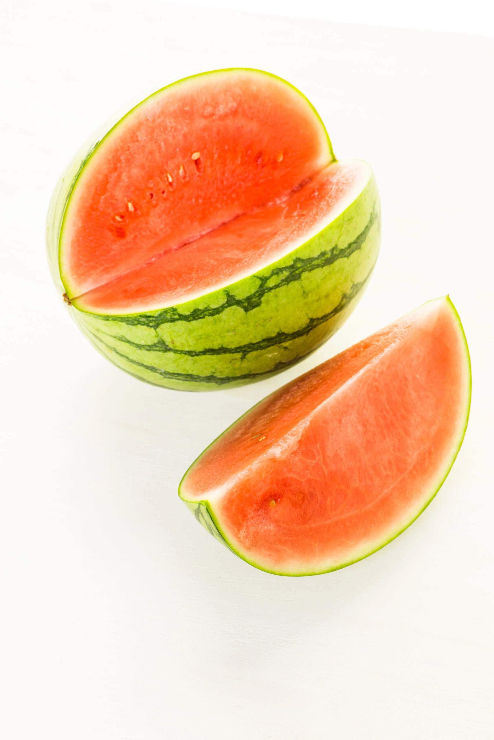 Halved red watermelon with green rind
