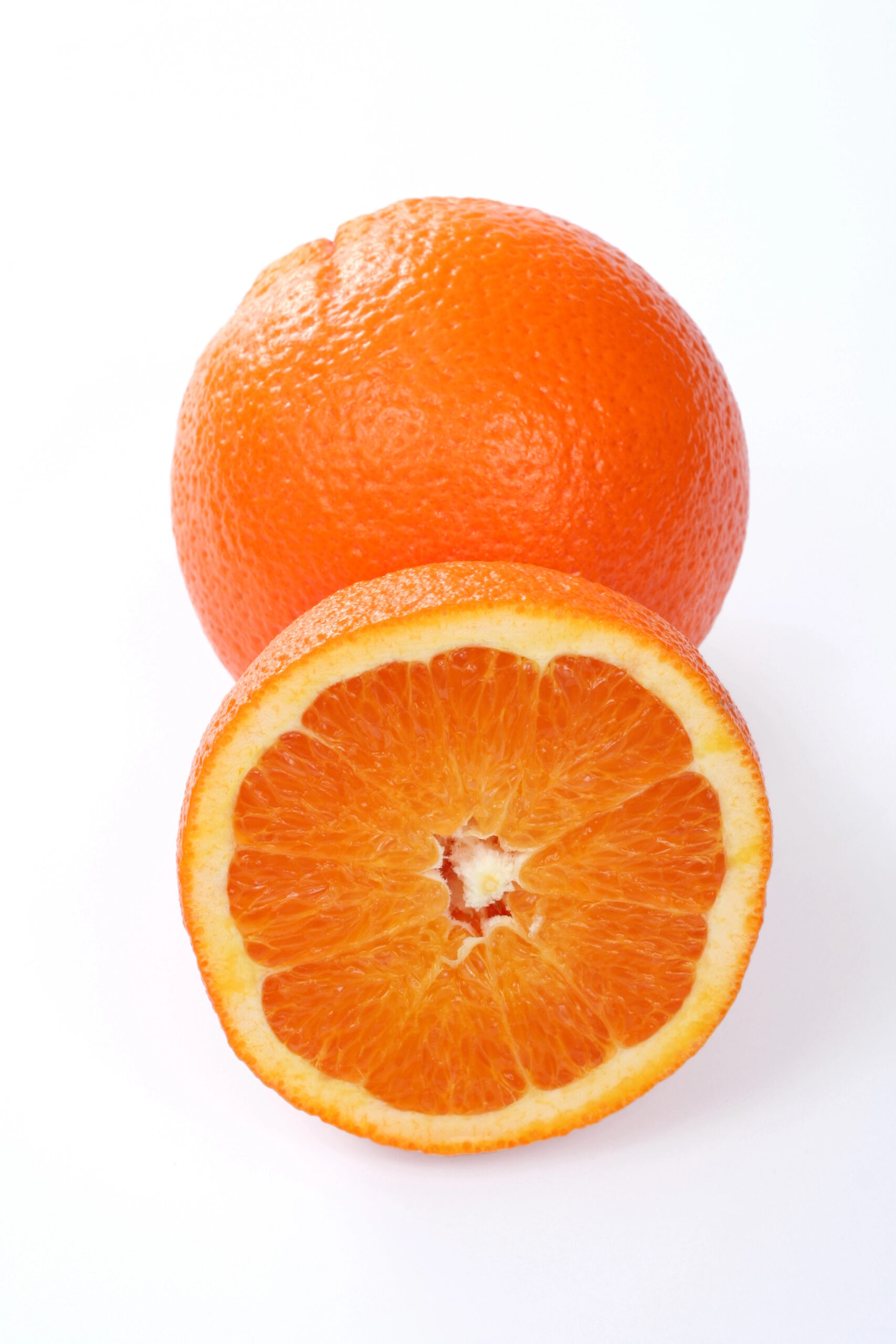 Whole orange and halved orange showing flesh