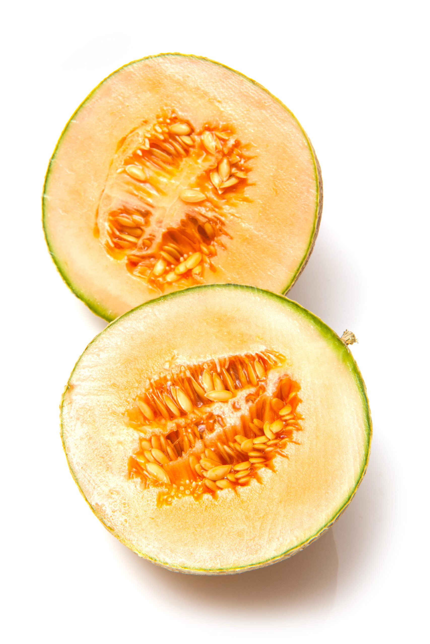 Two halves of cantaloupe melon showing seeds and flesh
