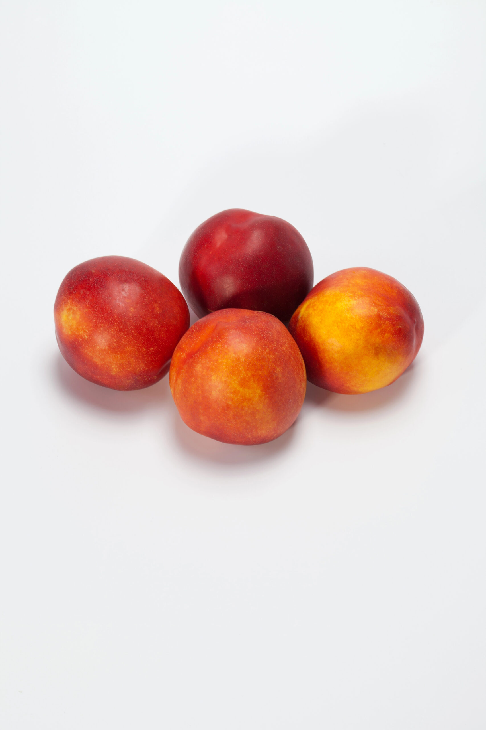 Four fresh peaches red and orange