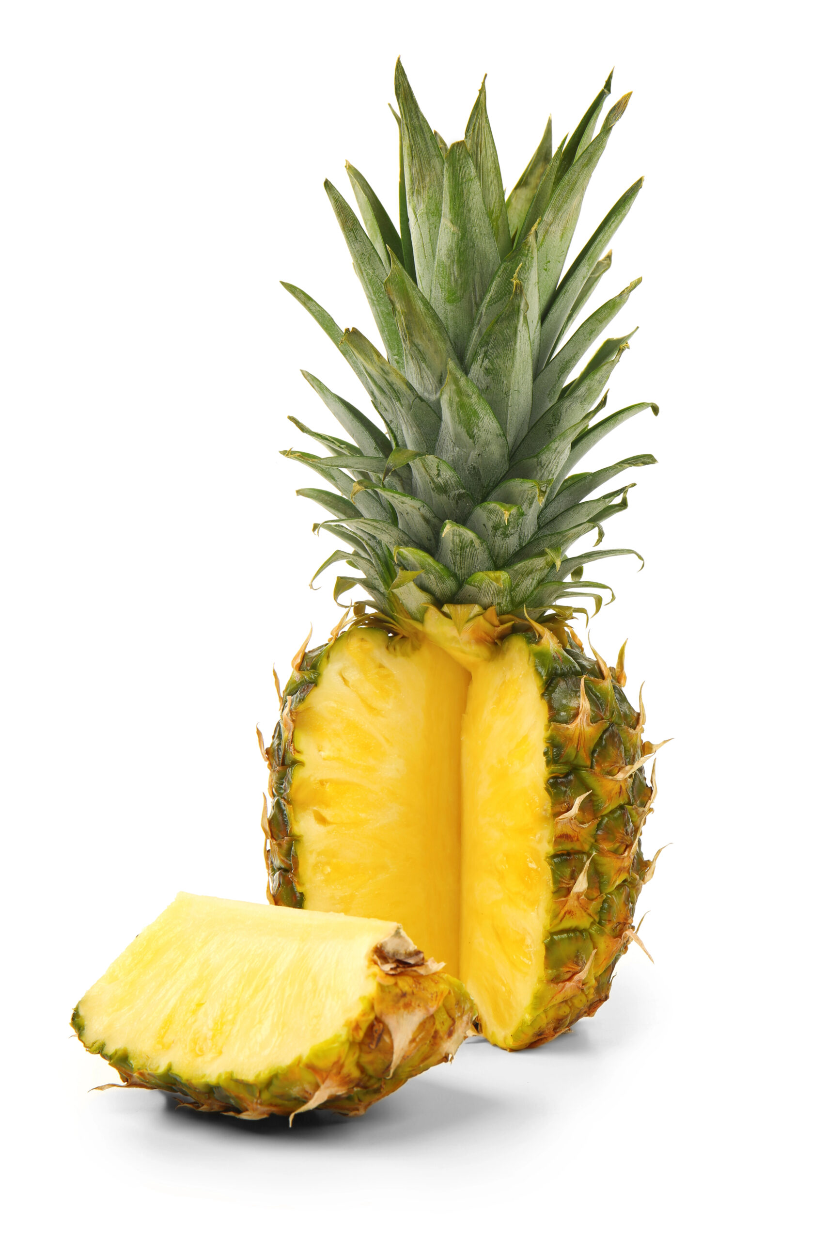 Whole and halved ripe pineapple with green crown
