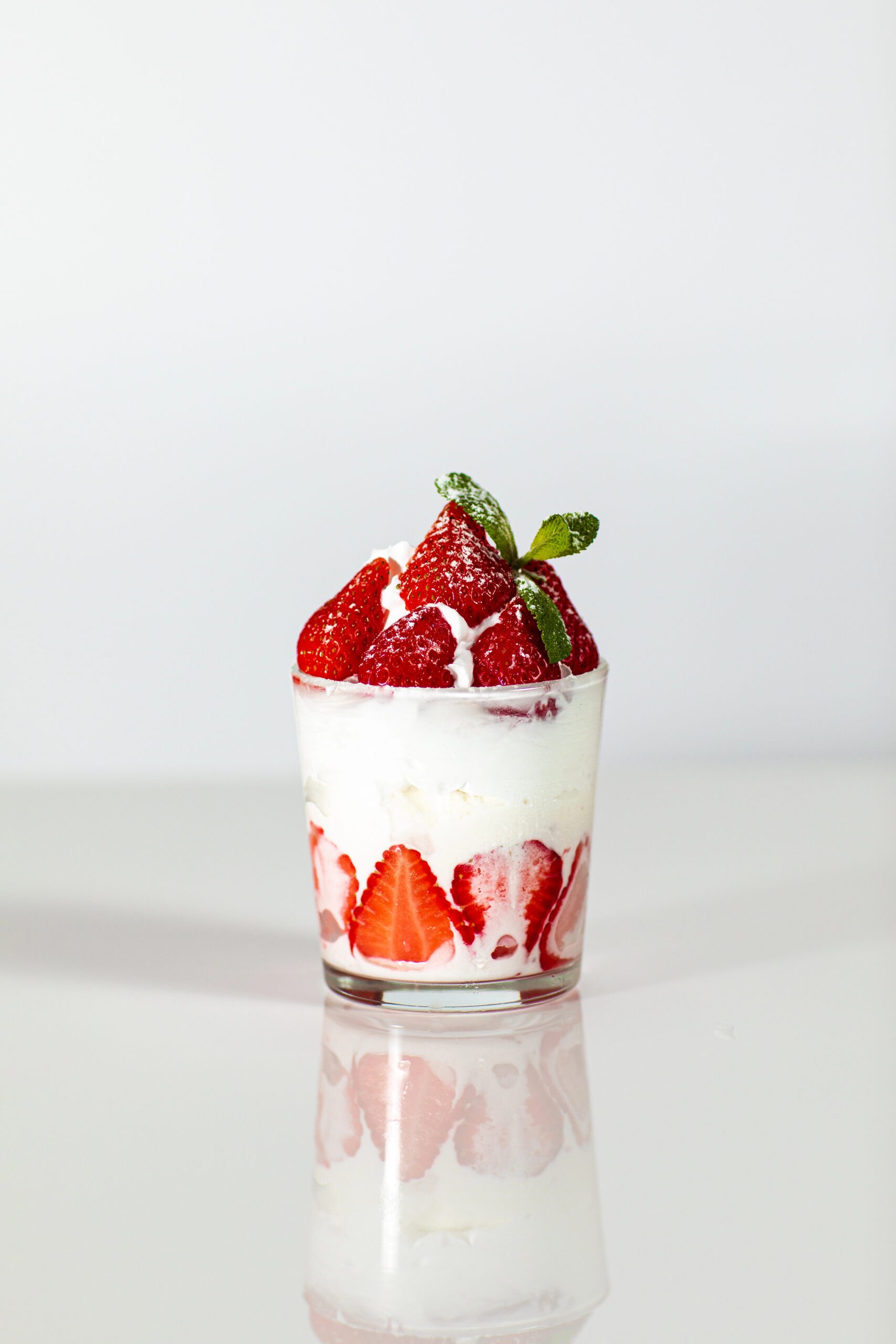 Strawberry and whipped cream dessert in glass