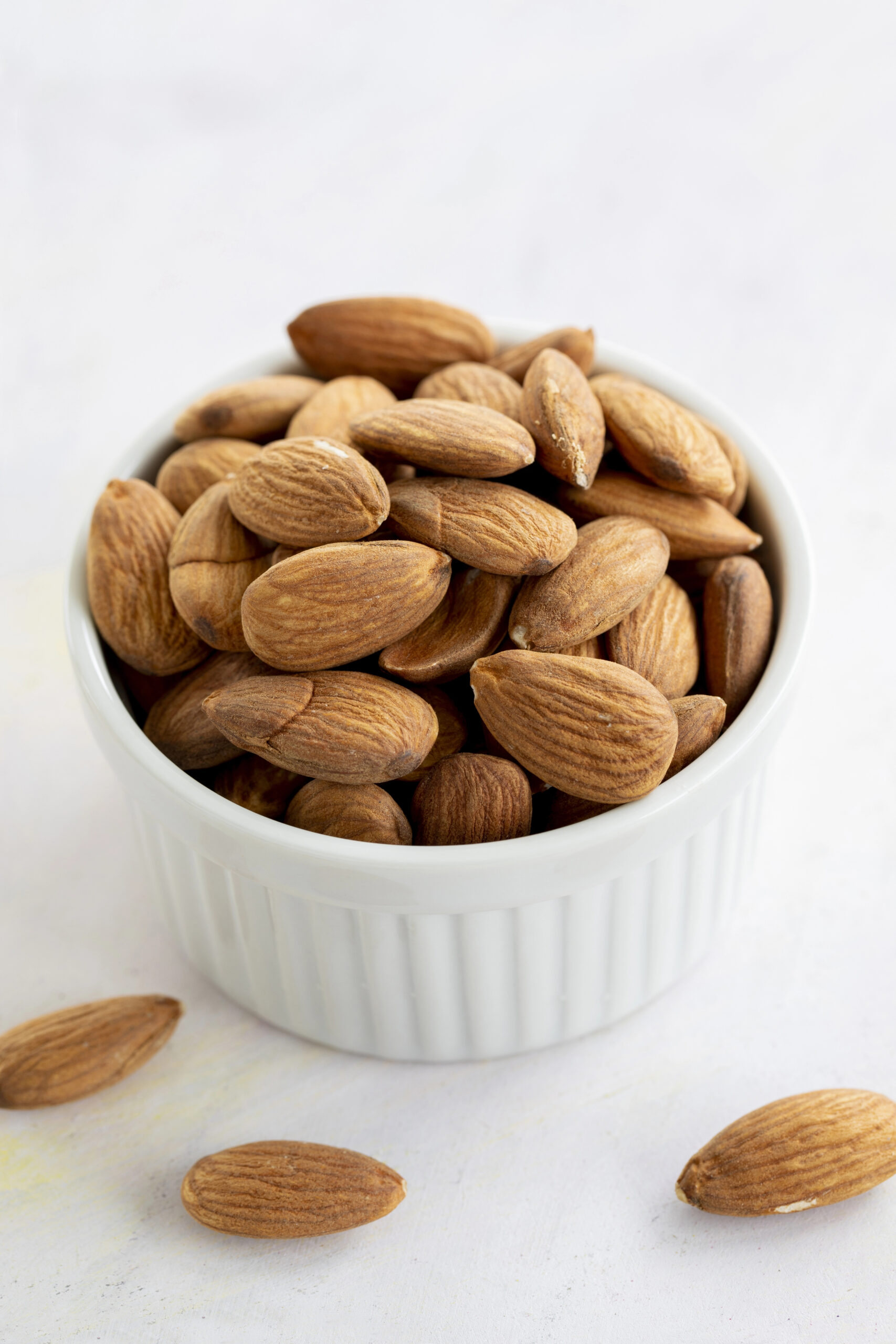 Whole almonds in white bowl