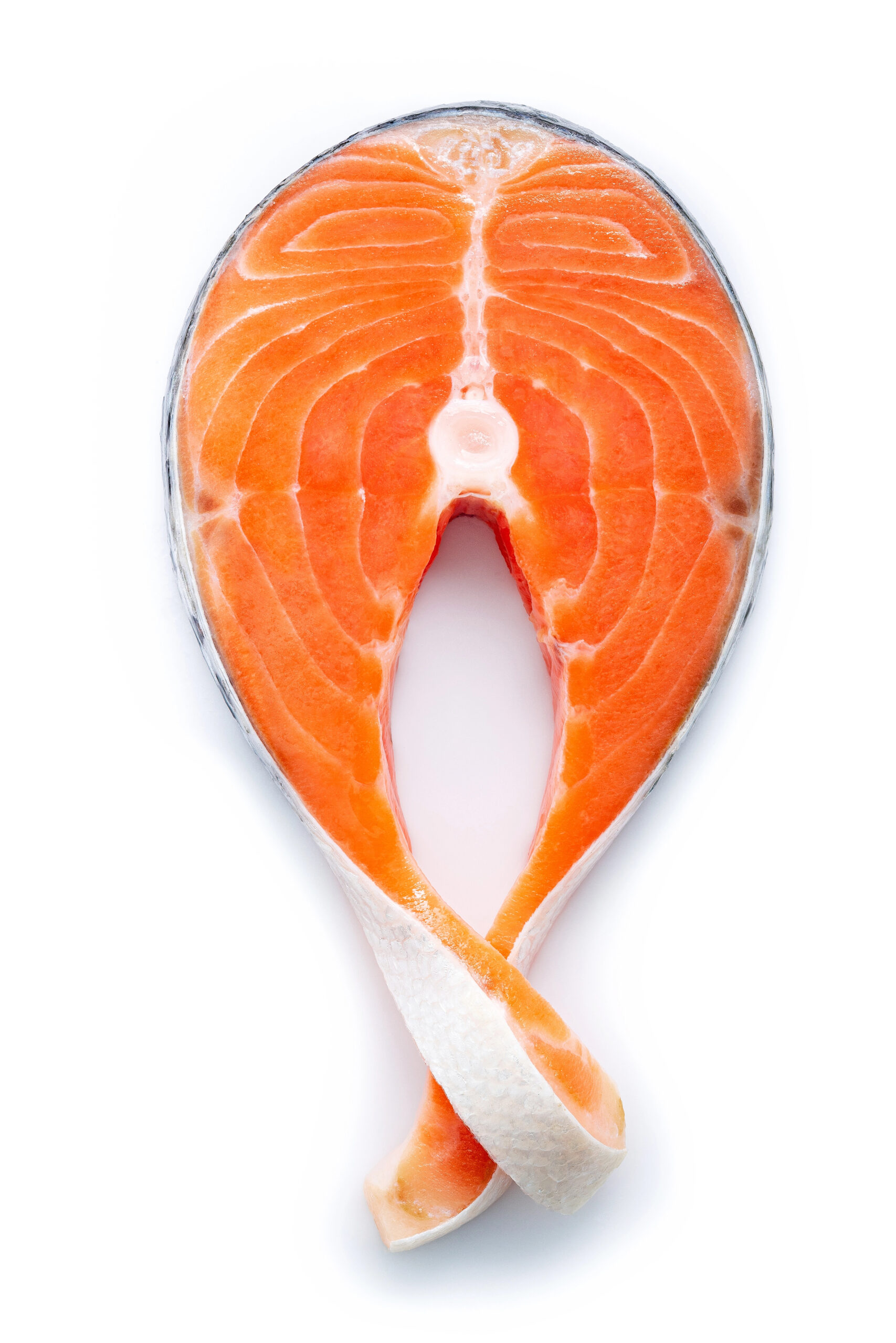 Raw salmon steak halved and opened flat