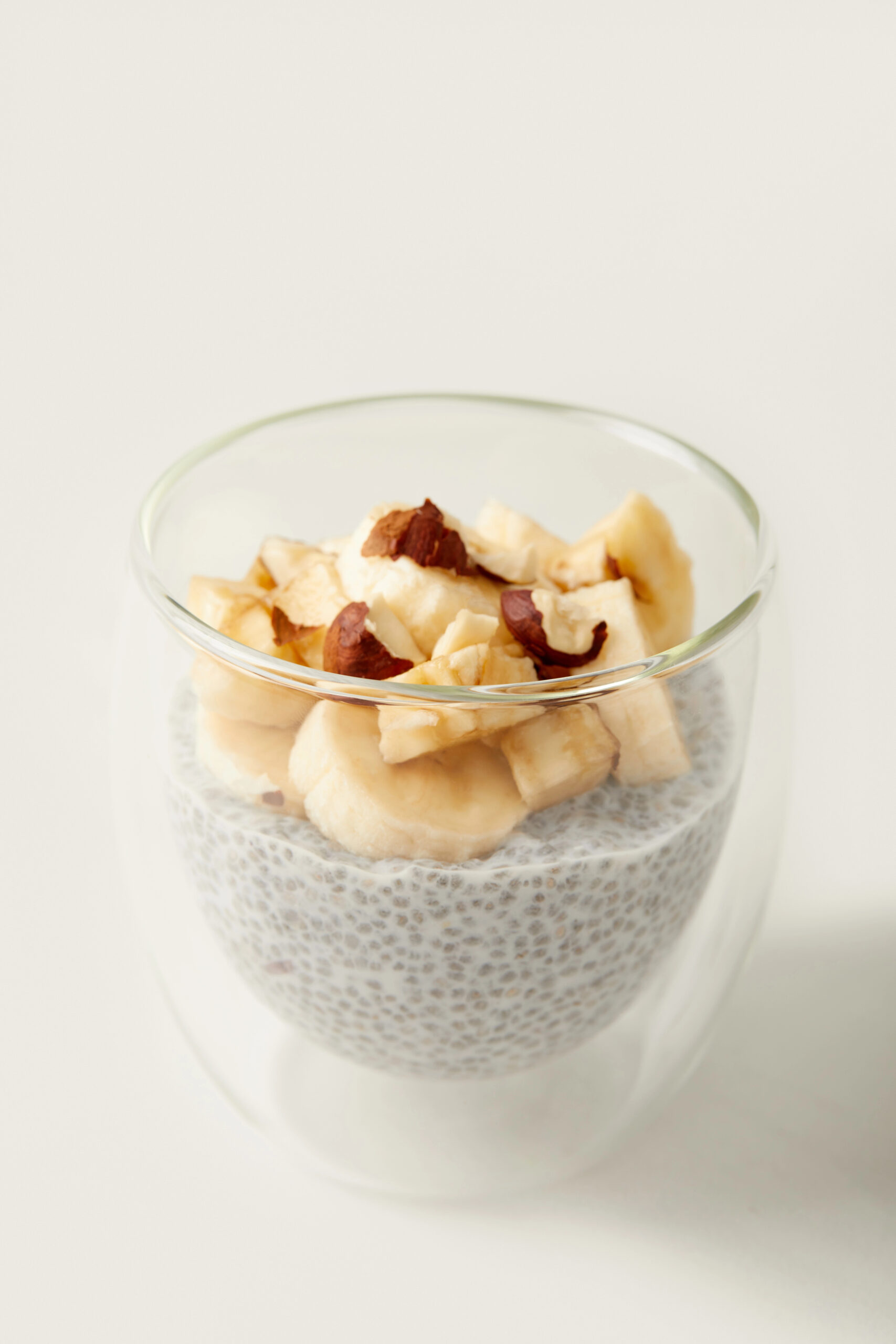 Chia seed pudding topped with banana and hazelnuts